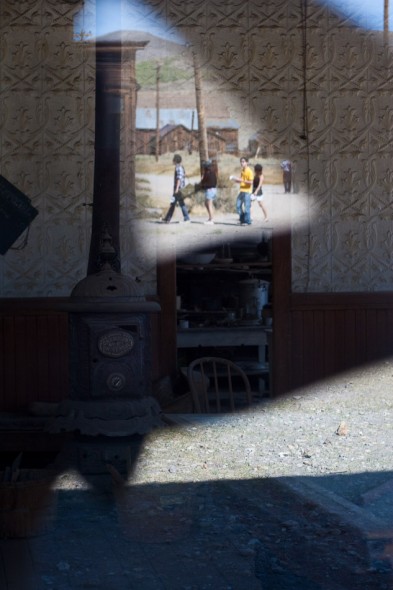 Tourists reflected in window