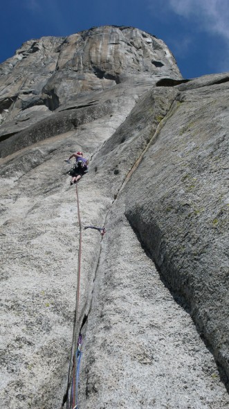 Helen jamming and laybacking up pin scars on the thin crack of pitch 4. Free Blast (11c).