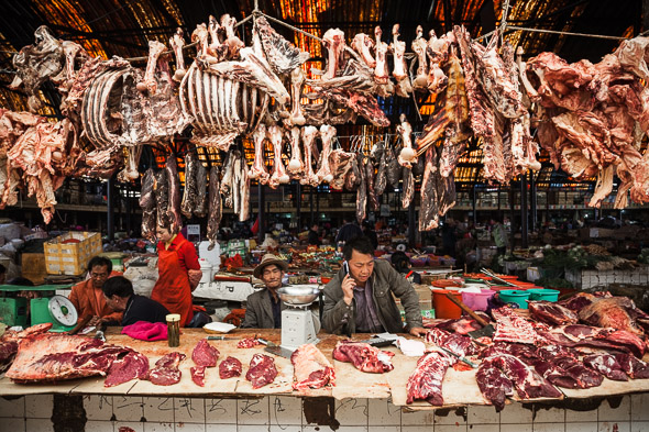 Butcher, Zhongdian market. Yunnan, China.