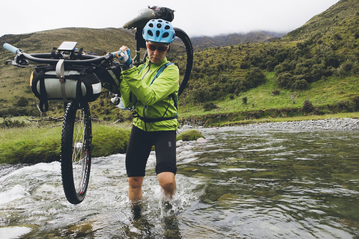 Hana crossing the Henry River (two crossings required to reach the hut from our route down the Waiau, although a swing bridge can be used on one). 