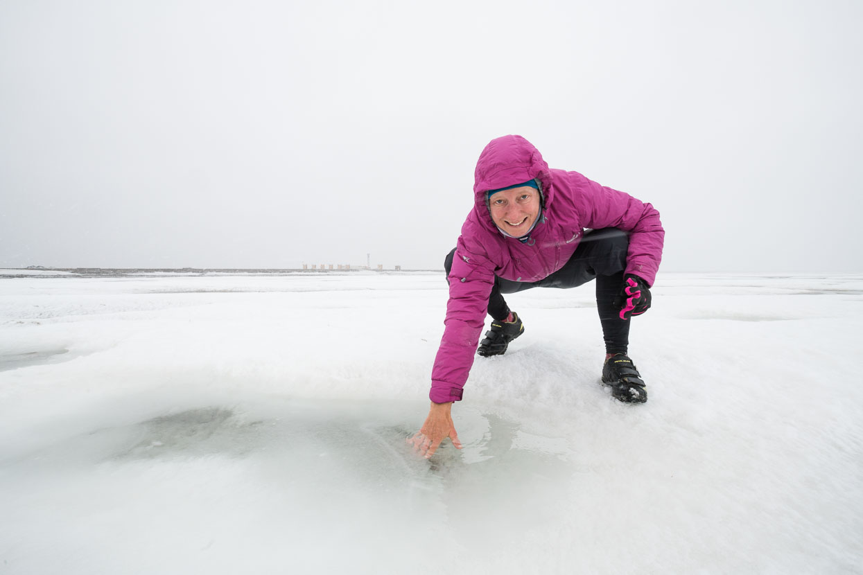 Dipping a hand in a puddle on the sea ice of the Arctic Ocean.