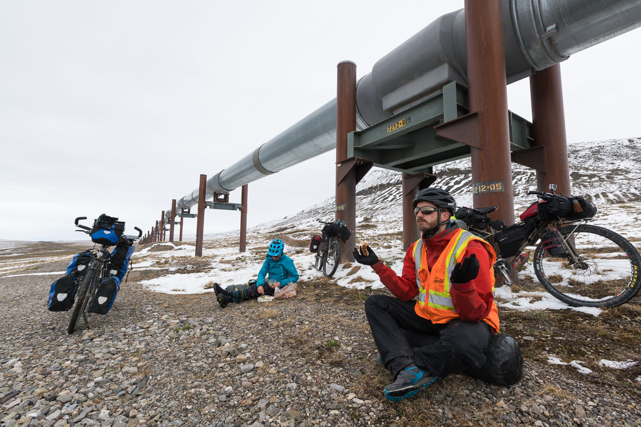 Lunch under the pipeline. Some clever mechanisms prevent the warm oil from melting the permafrost (and undermining the foundations) by cooling the supports with refrigerant. We had to isolate ourselves from the ground to prevent the permafrost from freezing us!