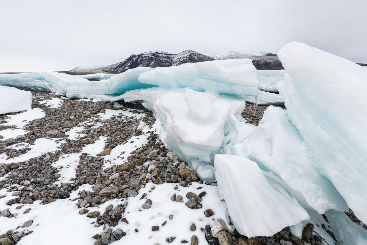 Left behind are serac-like blocks, distinctively layered and fractured.