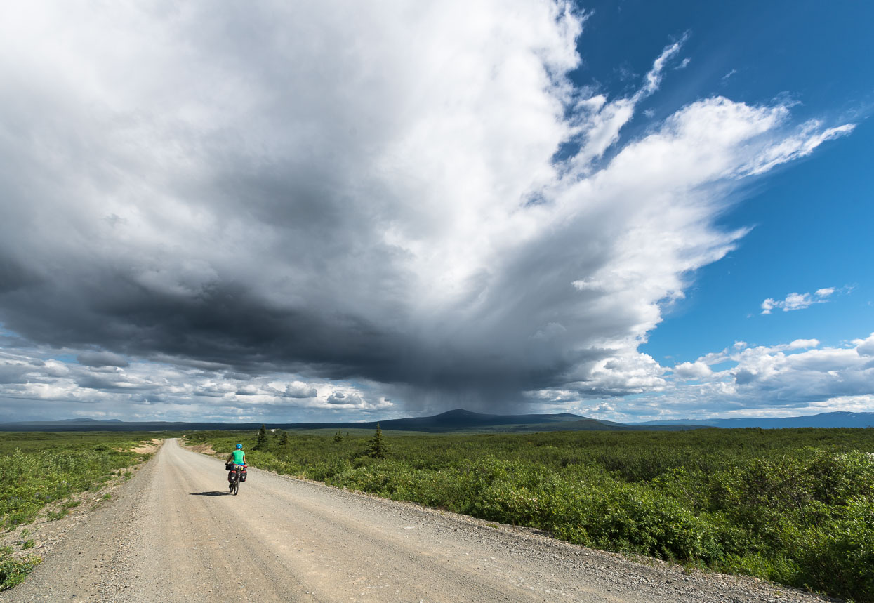 The road crosses a high alpine basin – wider than the eye can see and dotted with the tell tale features of a land formed during the twilight of the last ice age. It's also an ideal storm brewer and we watch thunderheads morph throughout the afternoon, fortunately only catching a brief shower from the edge a passing downpour and hailstorm.