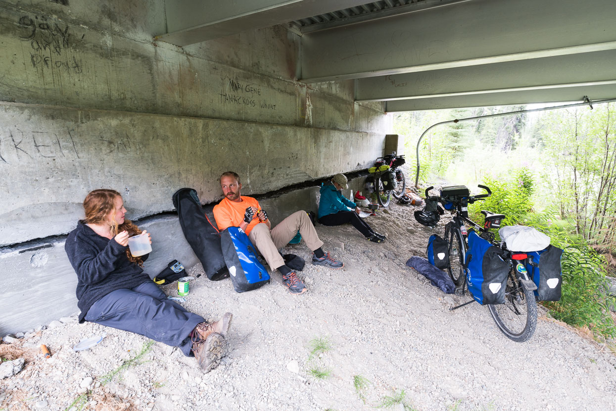 At Red Eagle lodge we had met Katie, an English cycle tourist headed through Alaska and down Canada and the USA to San Diego. Katie joined Hana, Rik and I for the next couple of days to Tok. A showery evening sent us to the sanctuary of a highway bridge for the night's cooking and we pretended to be homeless people.