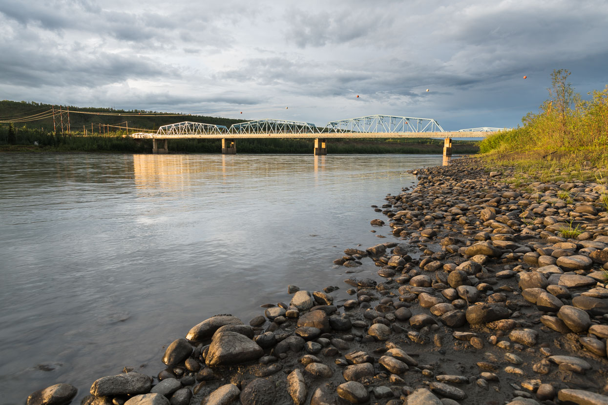 Pelly River bridge from the campsite. It was the hunt for gold that forced these remote highways north and the current Klondike Highway parallels much of the original gold route. Bridges now replace the ferries that once crossed these formidable rivers.