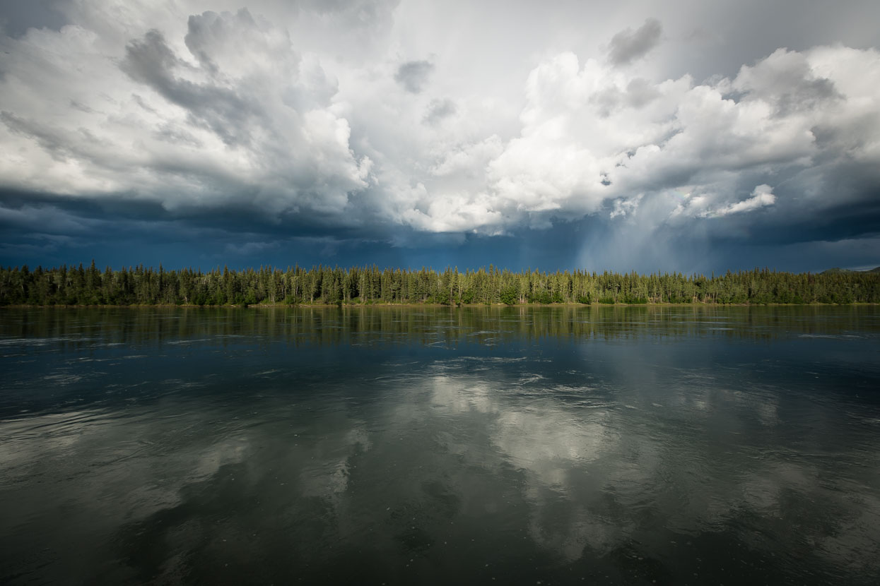 A thunderstorm brews beyond the Yukon River at Carmacks, another small town along the highway. The river is a couple of hundred metres wide at this point, dead flat, deep and swiftly moving. We camped a stone's throw from the banks in a small privately run campground.