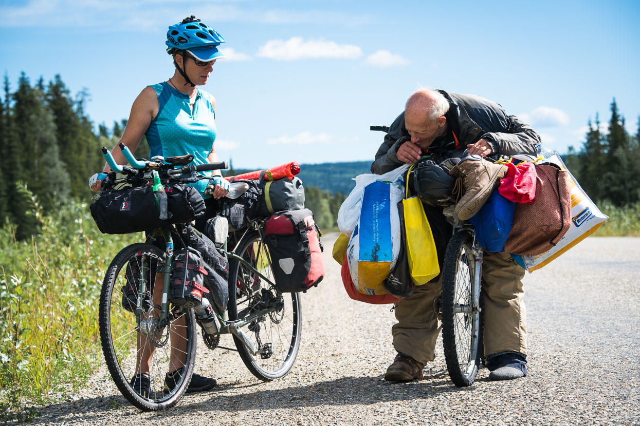 14 kilometres from Watson Lake we spotted a very slow moving, stooped form on a bicycle, and Hana recognised it to be a fellow she'd seen riding out of town about 4pm the previous afternoon. Alfred told us he'd been on the move all night – mostly slowly scooting his heavily draped bike – due to two nearly flat tyres. We chatted for a while and learned that he was aiming for Whitehorse, several hundred kilometres NW, where he hoped to 'sort his bike out'. Alfred was very chatty and full of ambitous and somewhat eccentric ideas that he shared with us, but it was hard not to feel sorry for this old man attempting make an existence from trash and found objects from the roadside. After 15 minutes of chatter we gave him some food and water and turned occasionally to see him shrink into the distance as we rode away.